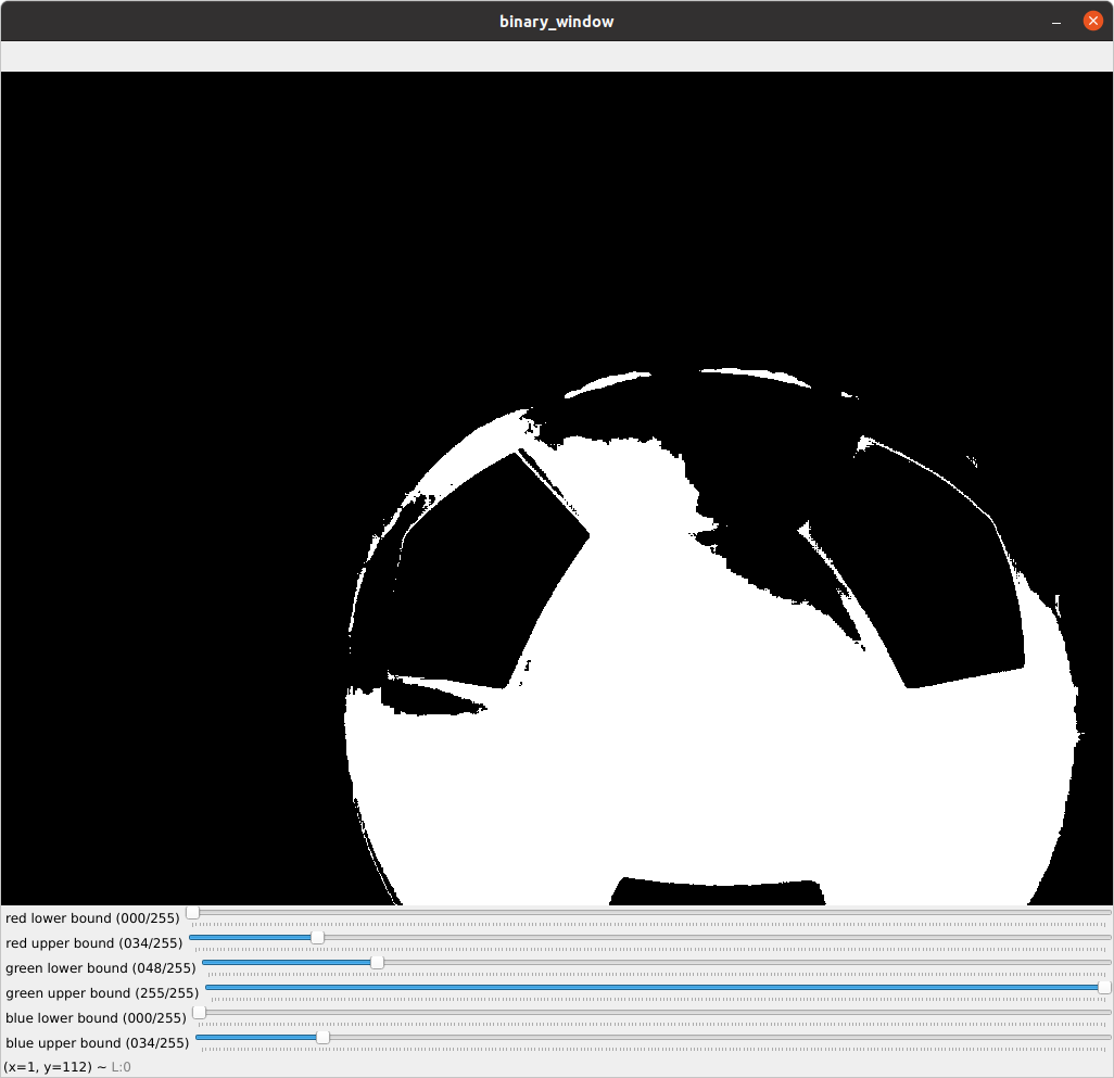 A thresholded image of a ball where pixels are colored white if they fall within predefined colored ranges and black otherwise